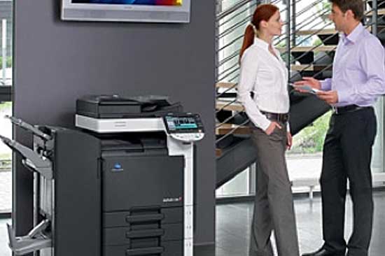 People standing around a copier in the office